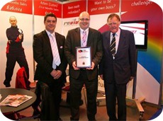 Andy Frounks, lead external verifier for IMI Awards presents the IMI centre approval award to Mark Llewellyn, managing director of Revive!(centre) on the company’s stand at the recent British Franchise Exhibition. Sir Bernard Ingham, president of the British Franchise Association (right) was the first to congratulate Revive! on the accreditation.