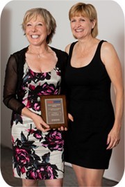 Jenny Boreham receives her award from FASTSIGNS International CEO Catherine Monson.