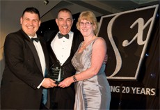 Franchisee of the year award winner Ken Bevis with his wife Judy and Managing Director Craig Brown (left) at the 2009 convention.