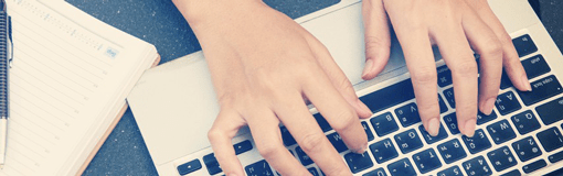 Hands typing on keyboard