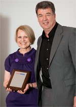Janie receiving her award from UK Managing Director, Garth Allison.