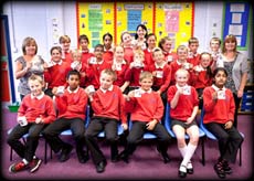 Mrs Metcalfe, yr 6 teacher (left) and Mrs Naughton, Teaching Assistand (right) with Yr 6 children at St Mary Magdalen’s CE Primary School in Accrington holidng their leaving mugs
