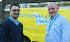 Two men in front of van