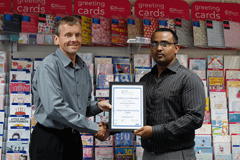 Two men holding award