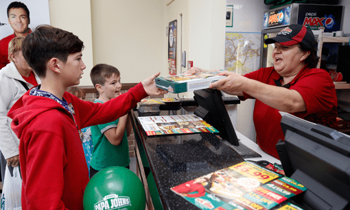 Children getting pizza at Papa John's counter