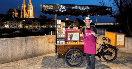 Man in front of Coffee-Bike in Germany