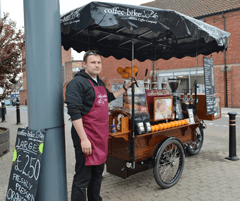 Man standing beside Coffee-Bike cart