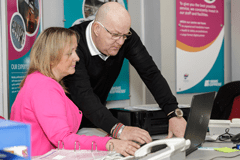 Jane and Ray at laptop in Signs Express office