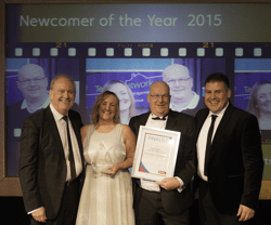 Four people holding award