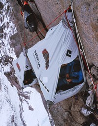 Photo Credit to Alastair Lee: Leo Houlding hanging out 2000 feet up the mighty north face of Mount Asgard. He spent 12 days on the cliff sleeping in his Port-a-ledge (as in portable ledge) that was branded by Recognition Express Cumbria