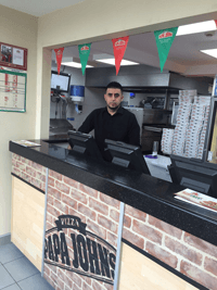 Man behind Papa John's counter