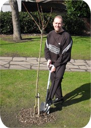 Nigel Hawkin plants a Cherry tree to recognise 5 years of owning Recognition Express Wakefield 